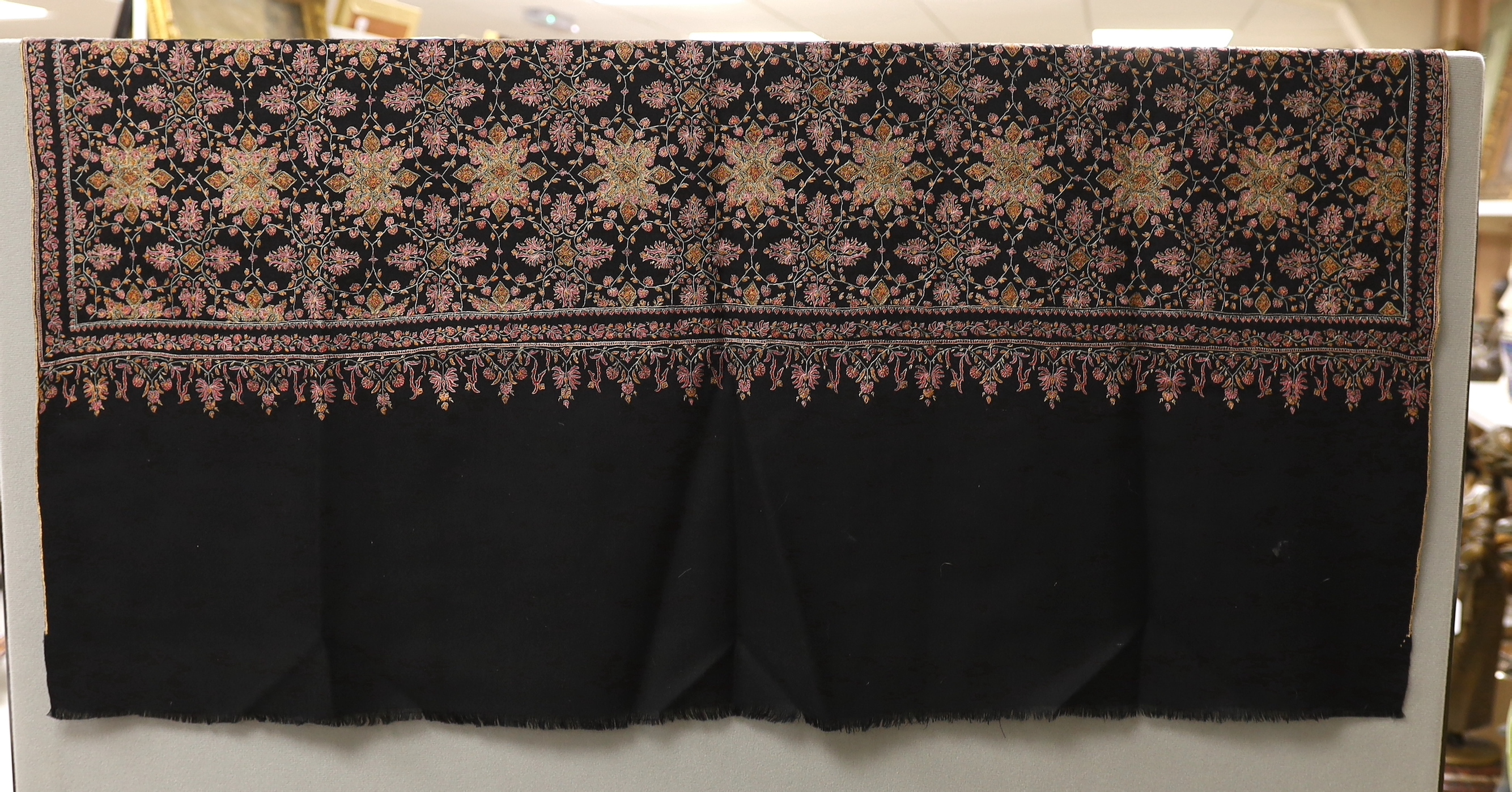 A very finely hand embroidered multicoloured silk black cashmere stole, with embroidered signature and number, 198cm long x 95cm wide